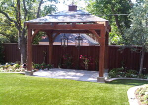 A gazebo with lights and a lawn in the background.