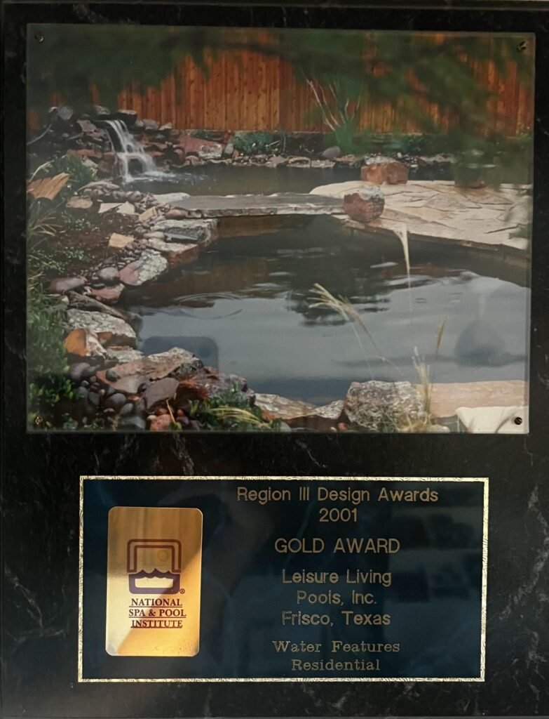 Natural stone waterfall and pond water feature with custom rock landscaping by Leisure Living Pools Frisco Texas - 2001 National Spa Pool Institute Gold Award winner residential water features