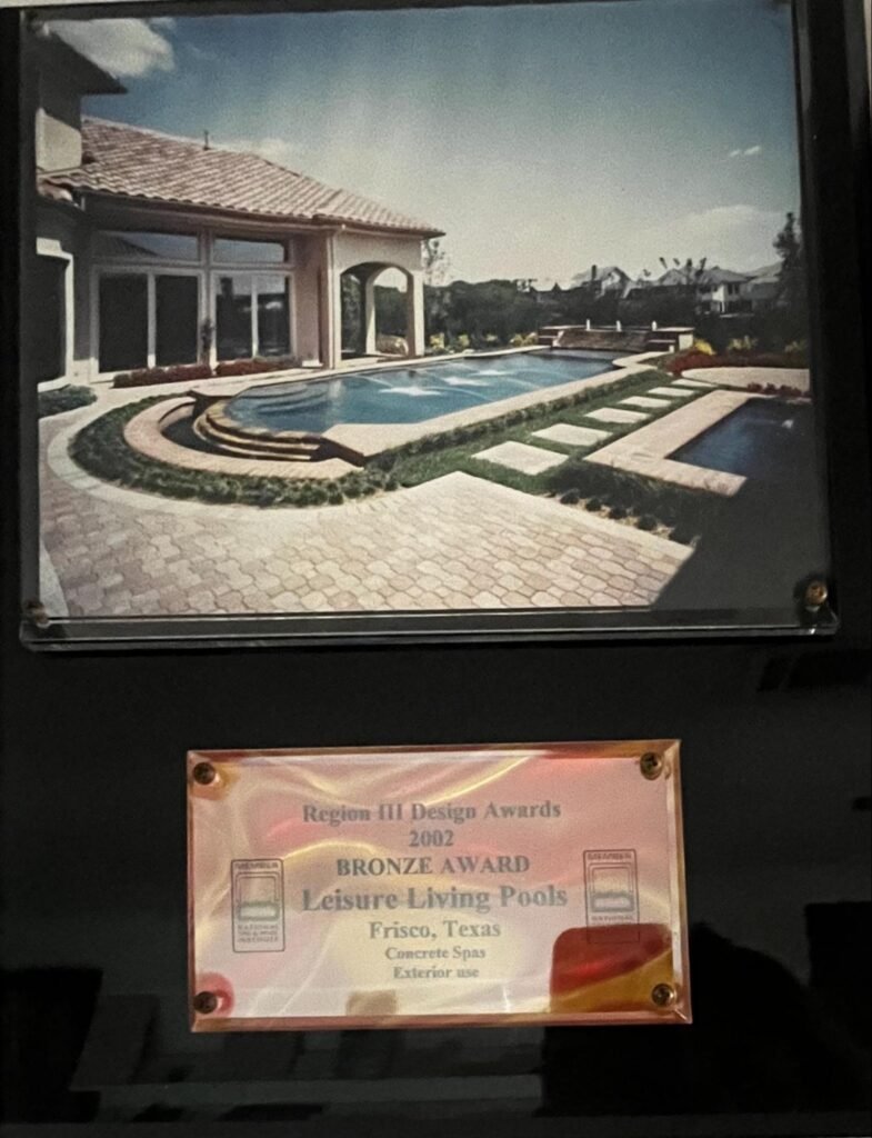 National Spa & Pool Institute 2002 Bronze Award plaque for Leisure Living Pools, Frisco, Texas concrete spa with curved steps and paver decking