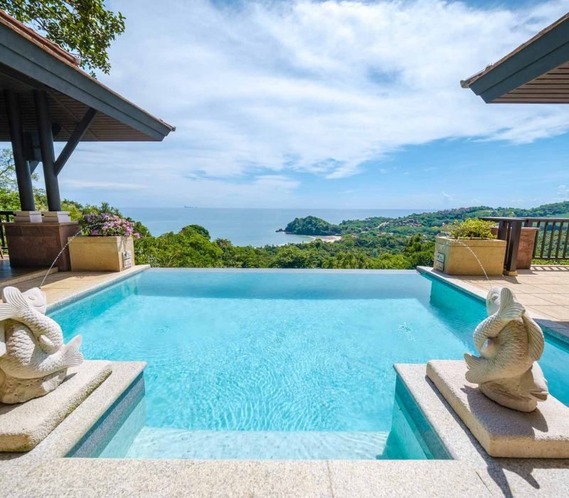 Infinity edge pool with decorative sculptures and ocean views showcasing Leisure Living Pools luxury custom pool designs Dallas Texas